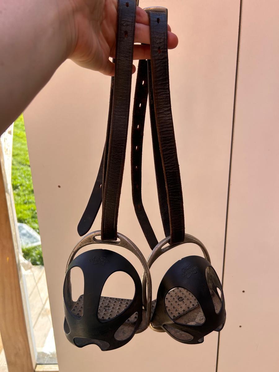 Cage stirrups for learner riders with brown leather stirrup leathers
